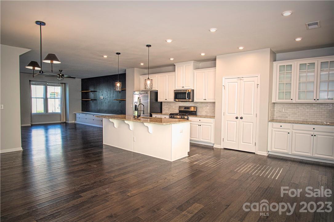 12725 Glowing Peak Road Huntersville, NC 28078 - Photo 2 of 17 a view of a kitchen with stove and cabinets