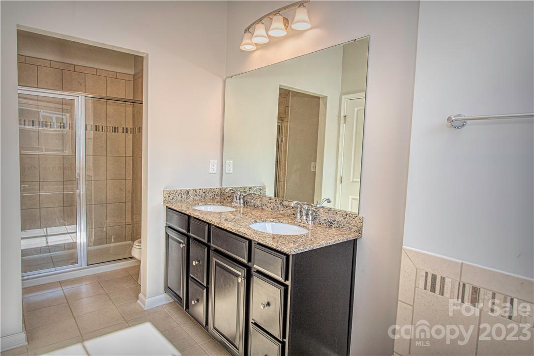 12725 Glowing Peak Road Huntersville, NC 28078 - Photo 7 of 17 a bathroom with a sink a toilet and shower