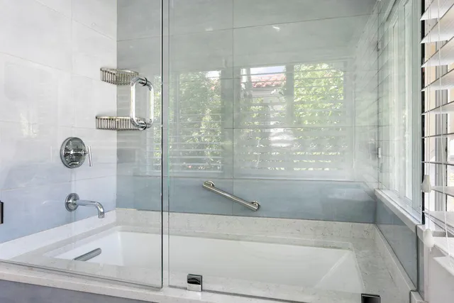 a bathroom with a bathtub and shower