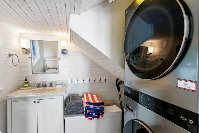a bathroom with a sink mirror and vanity