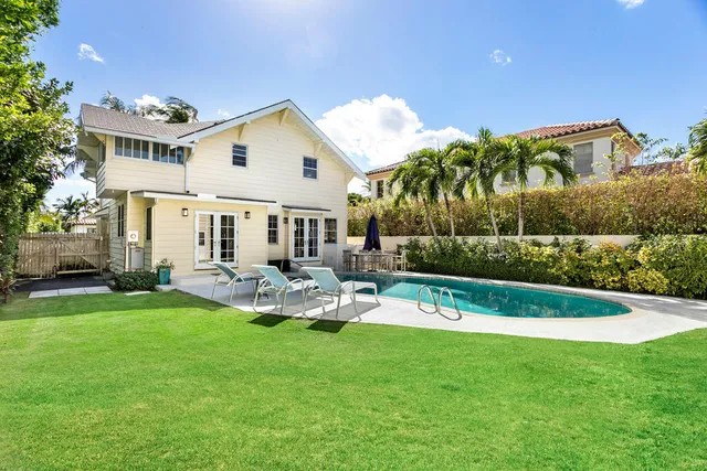 a front view of a house with a yard table and chairs