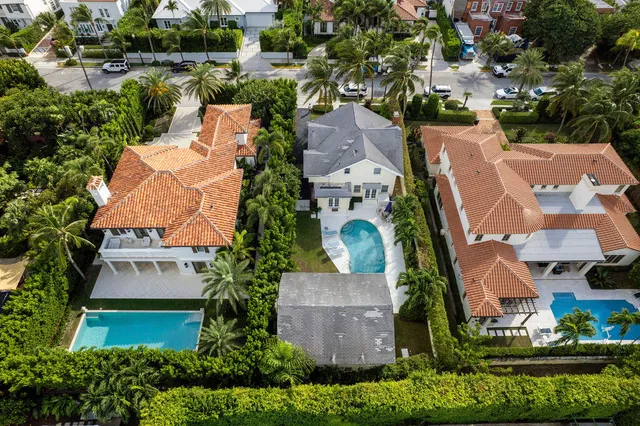 an aerial view of a house with a yard and lake view