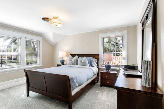a bedroom with a bed window and a desk