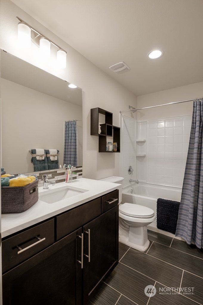 21529 6th Drive Southeast, Unit RM14 Bothell, WA 98021 - Photo 13 of 28 a bathroom with a sink a toilet and mirror