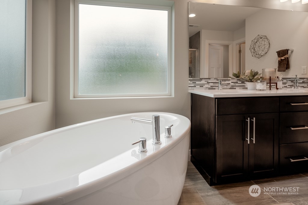 21529 6th Drive Southeast, Unit RM14 Bothell, WA 98021 - Photo 19 of 28 a bathroom with a bathtub and a sink