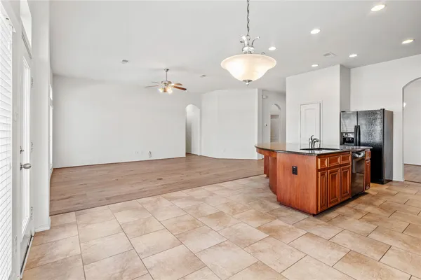 a large kitchen with kitchen island cabinets and stainless steel appliances