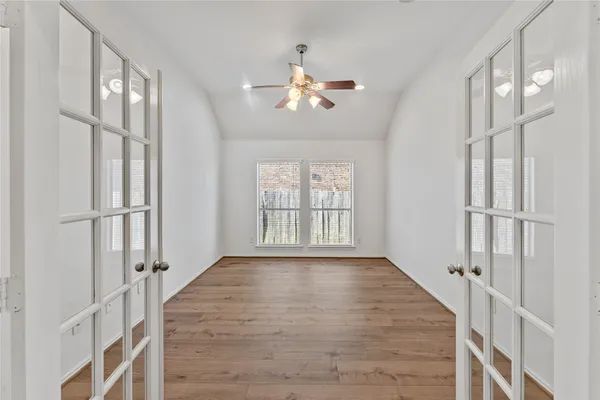 wooden floor in an empty room with a window