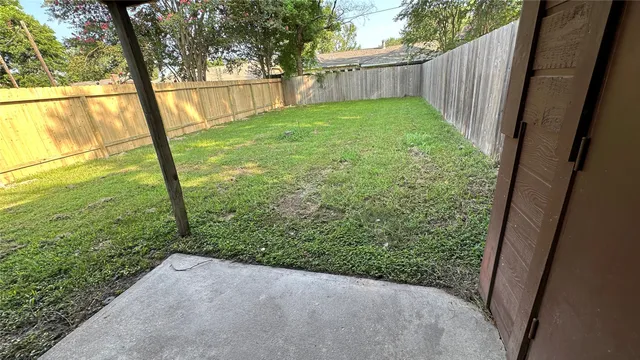 a view of a yard with trees in the background