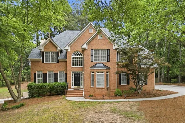 a front view of a house with a yard