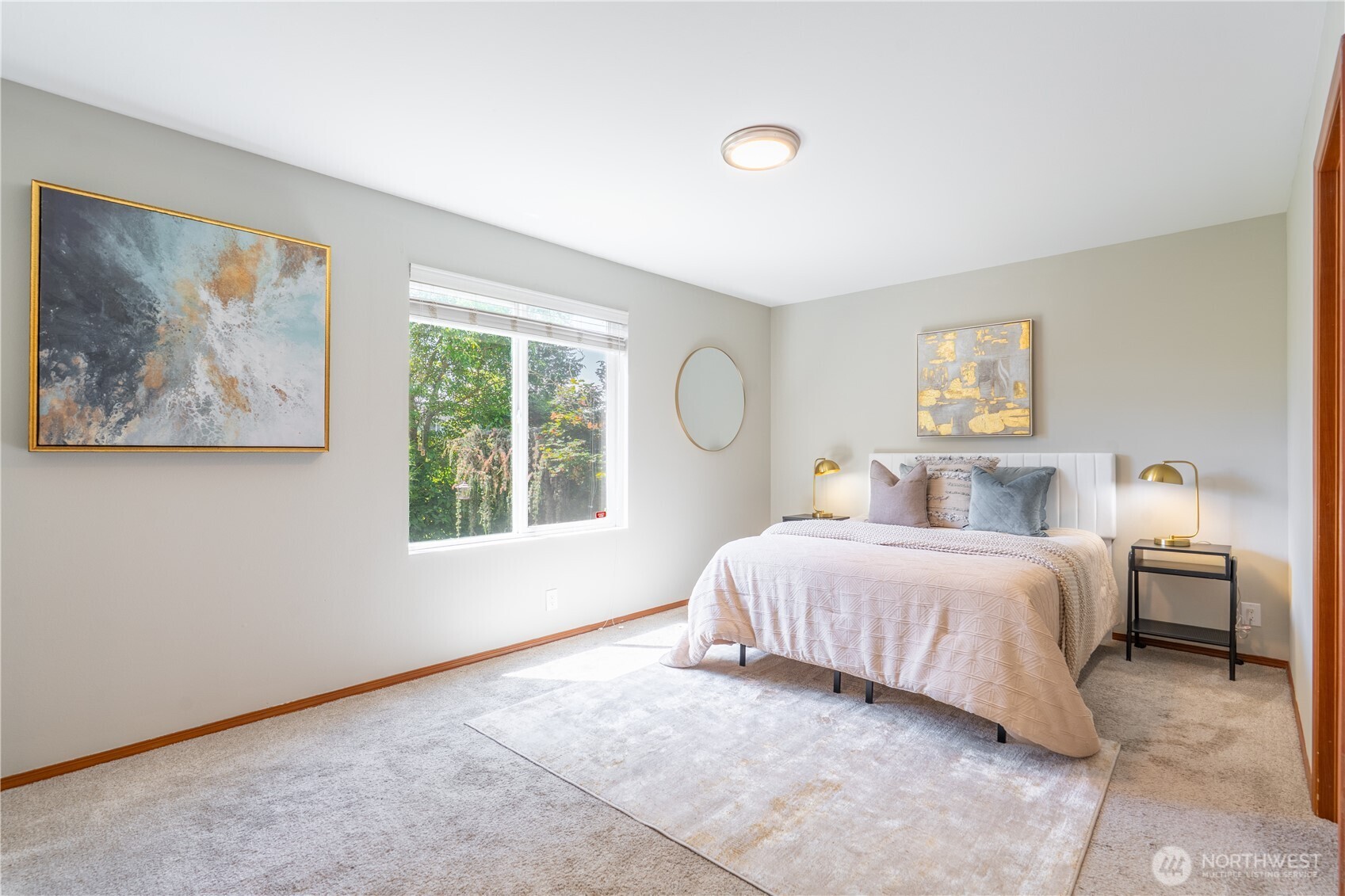 242 Riggs Drive East Enumclaw, WA 98022 - Photo 22 of 40 a spacious bedroom with a bed and a large window