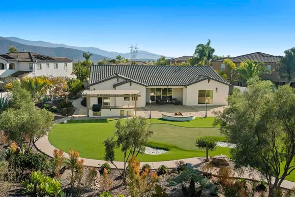 a aerial view of a house with swimming pool patio and outdoor seating