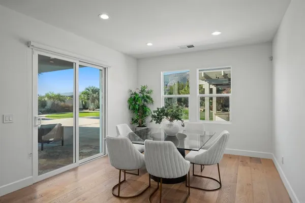 a bedroom with furniture and large windows