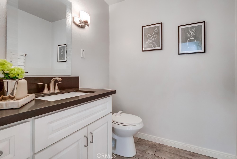 930 Ocean View Avenue, Unit E Monrovia, CA 91016 - Photo 15 of 36 a bathroom with a granite countertop toilet and a sink
