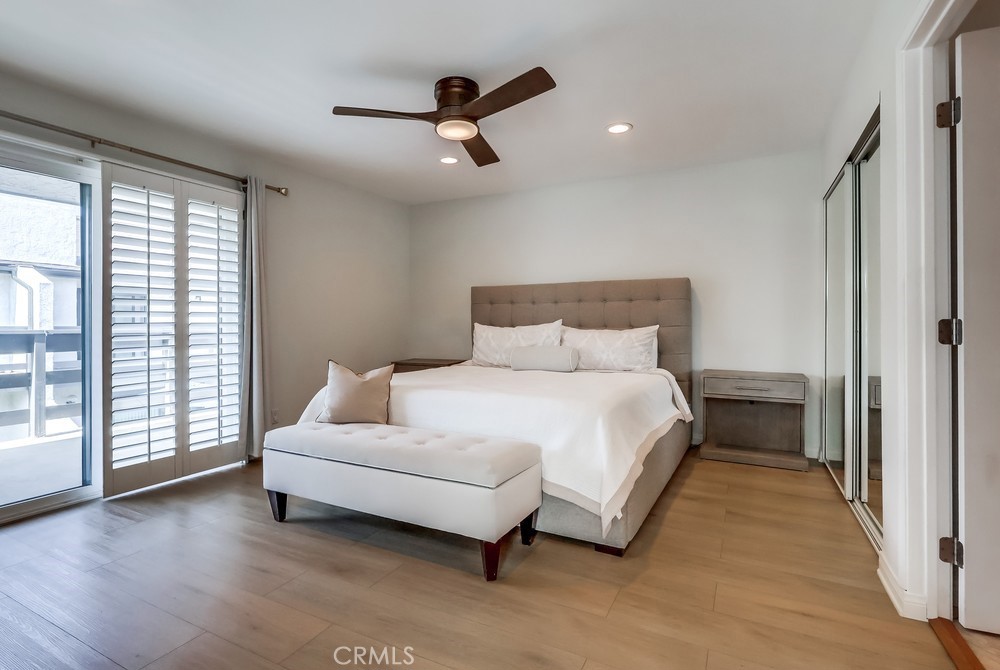 930 Ocean View Avenue, Unit E Monrovia, CA 91016 - Photo 17 of 36 a spacious bedroom with a bed and a large window