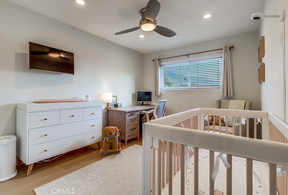 930 Ocean View Avenue, Unit E Monrovia, CA 91016 - Photo 23 of 36 a bedroom with furniture and a flat screen tv