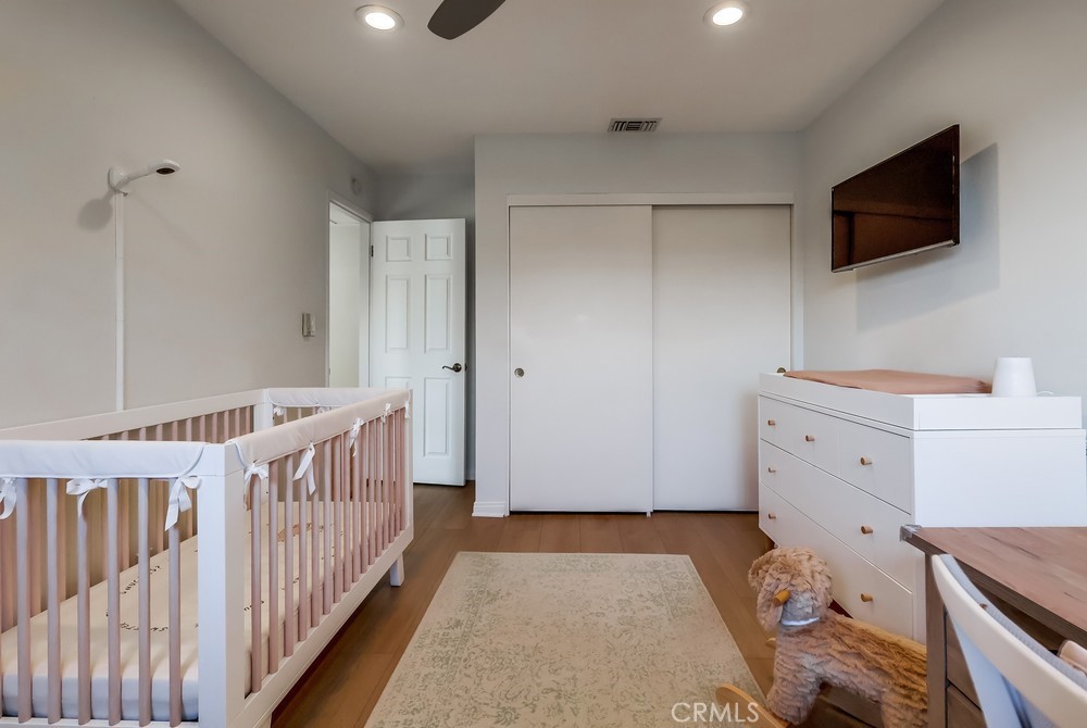 930 Ocean View Avenue, Unit E Monrovia, CA 91016 - Photo 24 of 36 a view of a bedroom with baby crib and furniture