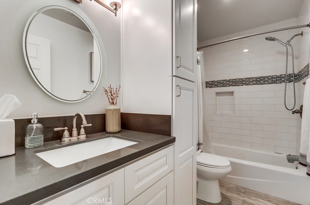 930 Ocean View Avenue, Unit E Monrovia, CA 91016 - Photo 27 of 36 a bathroom with a sink a toilet and a mirror