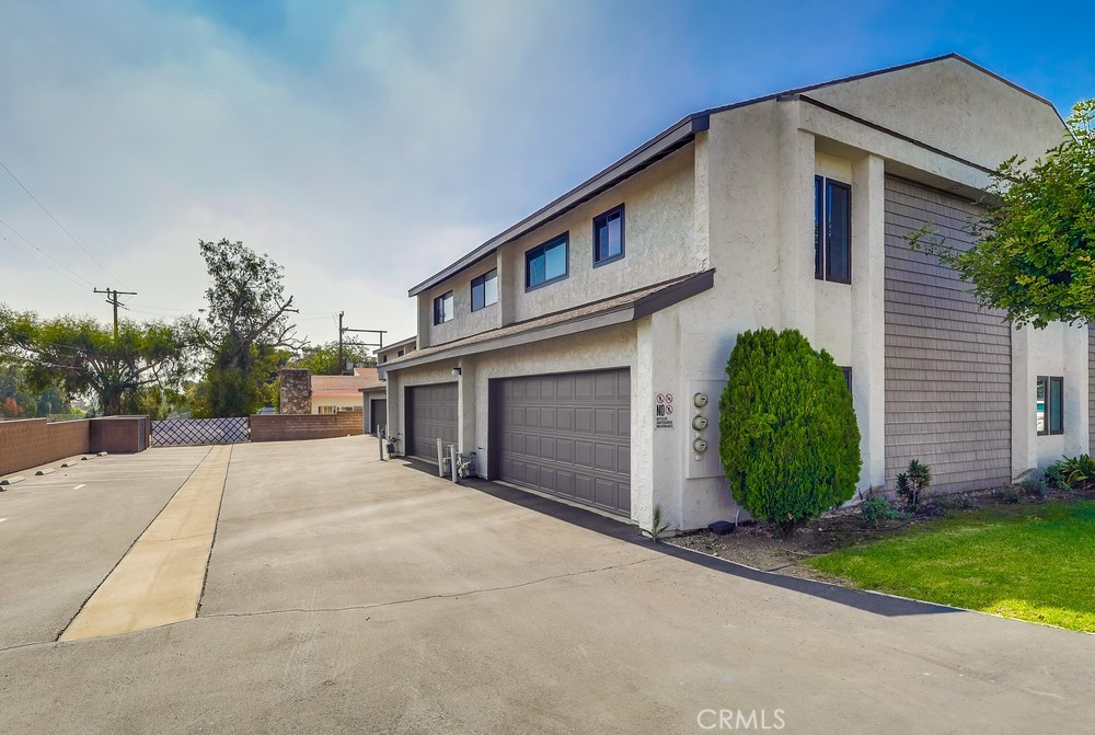 930 Ocean View Avenue, Unit E Monrovia, CA 91016 - Photo 32 of 36 a front view of a house with a yard and garage