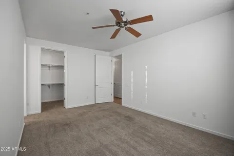 a view of walk in closet with empty racks