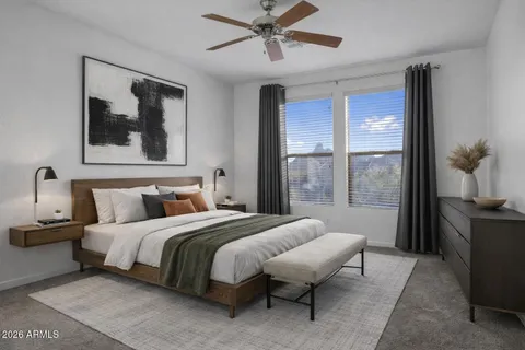 a view of a big room with windows and chandelier fan