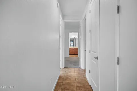 a view of a big room with windows and chandelier fan