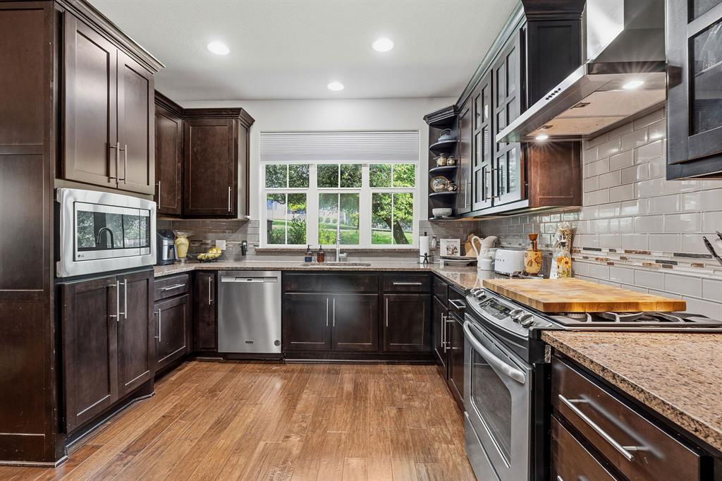 15317 Falconhead Grove Loop Austin, TX 78738 - Photo 4 of 29 Culinary haven with rich cabinetry, sleek stainless steel appliances, and ample counter space for inspired cooking.