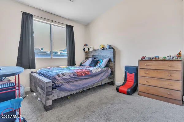 a bedroom with a bed and a dresser