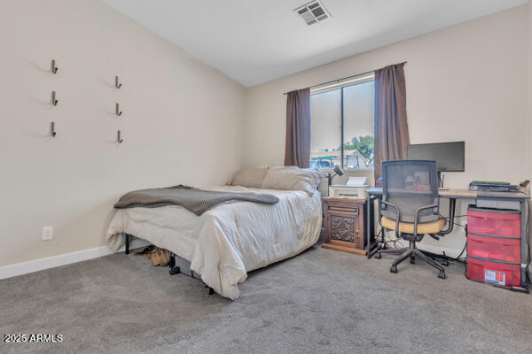 138 North Signal Butte Road Apache Junction, AZ 85120 - Photo 10 of 25 a spacious bedroom with a bed chair and a window