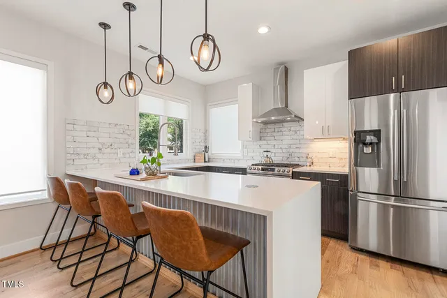 a kitchen with appliances cabinets and furniture