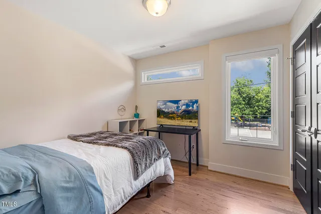 a bedroom with a bed and a window