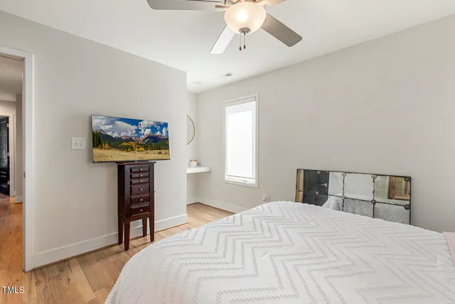 a bedroom with a bed and a dresser in it