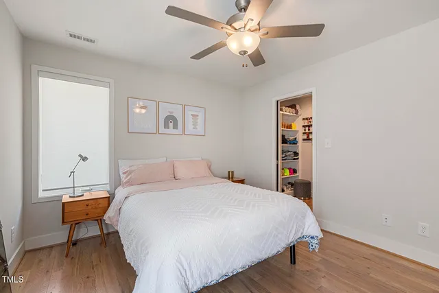 a bedroom with a bed and a chandelier