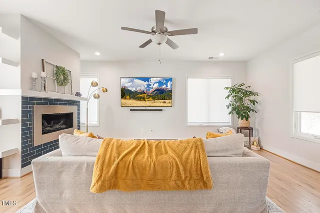 a living room with a balcony furniture and a fireplace
