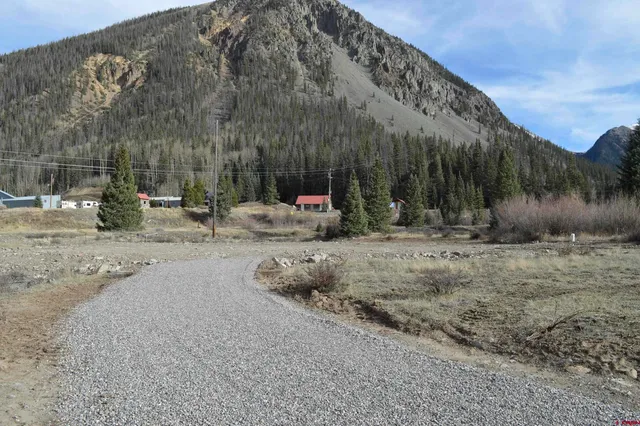 a backyard of apartments with large trees