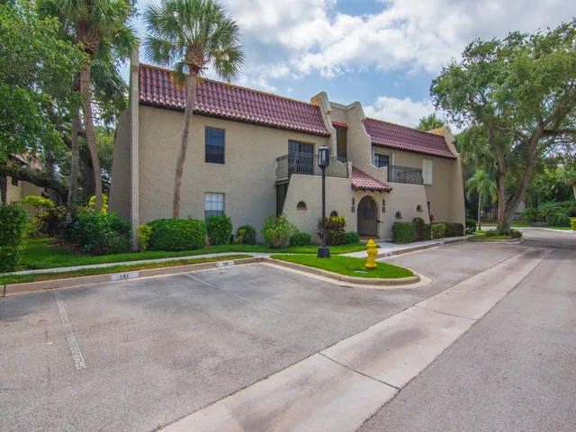a view of water with boats and trees in the background