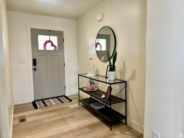 4349 Half Mile Road East Enoch, UT 84721 - Photo 12 of 36 Foyer entrance featuring light wood-style floors and baseboards