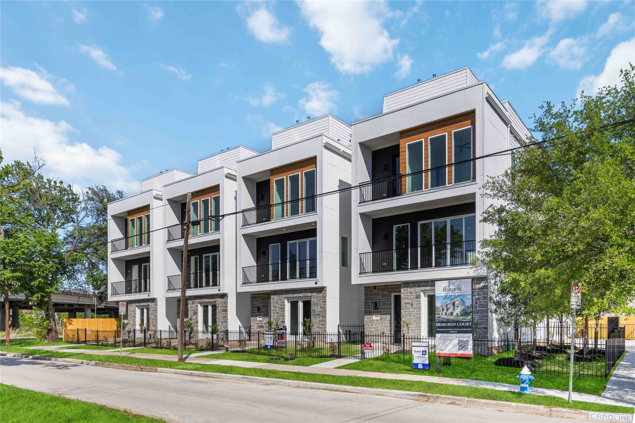 a front view of a residential apartment building with a yard