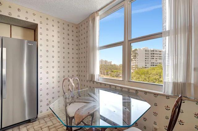 a bath room with a window and a chair