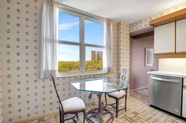 a dining room with furniture and window