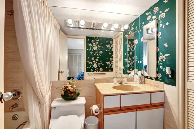 a dining room with furniture and a large window