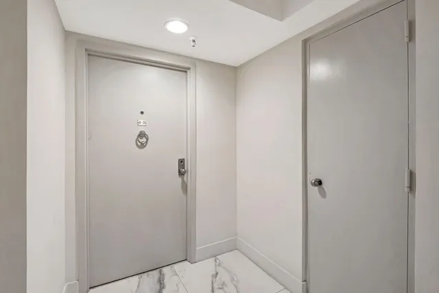 a bathroom with a shower and a glass door