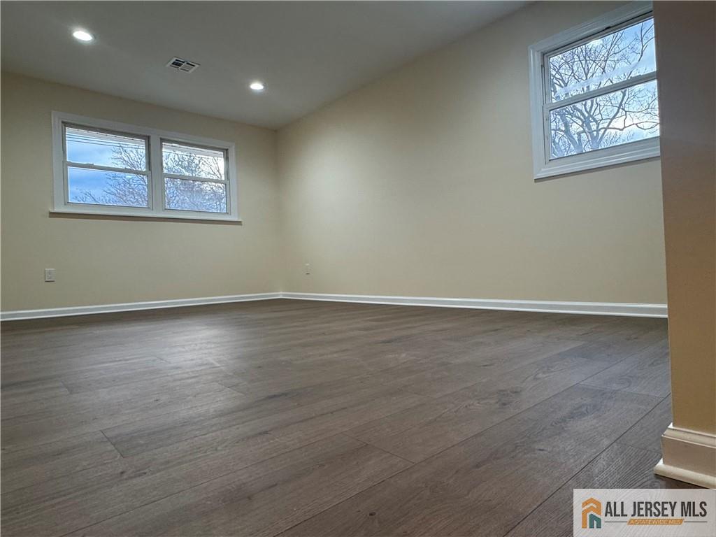 1868 Oak Tree Road Edison, NJ 08820 - Photo 19 of 24 an empty room with wooden floor and windows