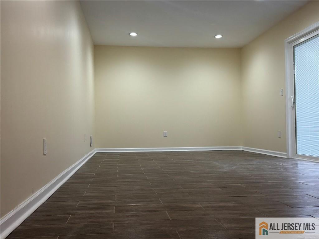 1868 Oak Tree Road Edison, NJ 08820 - Photo 6 of 24 an empty room with wooden floor and natural light