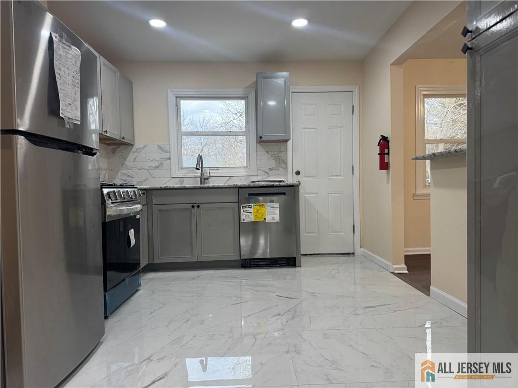 1868 Oak Tree Road Edison, NJ 08820 - Photo 10 of 24 a large kitchen with stainless steel appliances granite countertop a stove a sink and a refrigerator