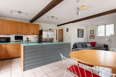 a kitchen with stainless steel appliances kitchen island granite countertop a sink and cabinets