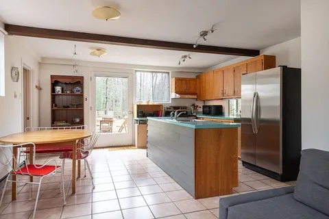a kitchen with stainless steel appliances granite countertop a refrigerator and a stove