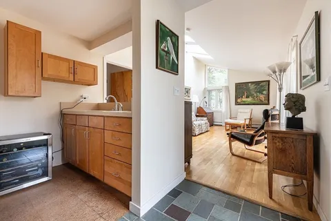 a living room with furniture a flat screen tv and a window
