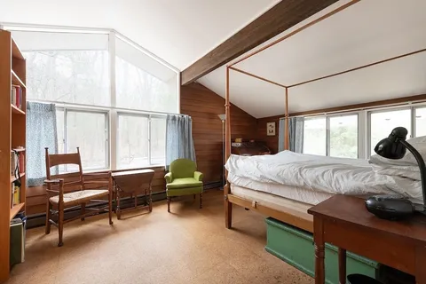 a bedroom with a bed and a window