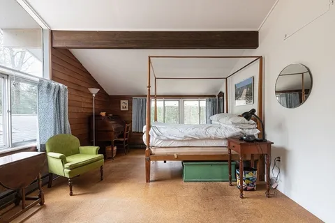 a bedroom with furniture and a window