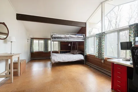 a bedroom with furniture and a window